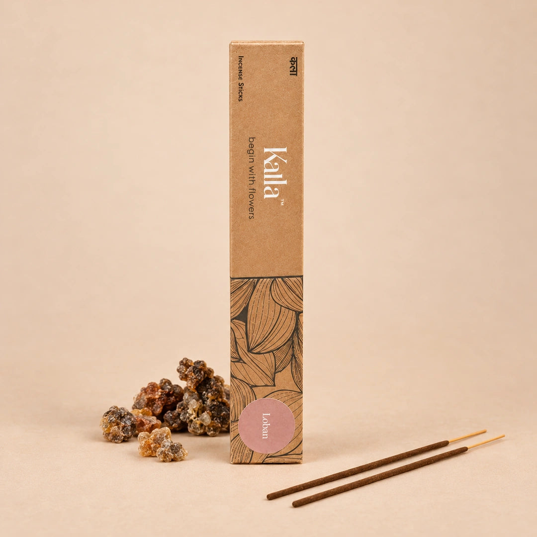 Kalla Loban Incense Sticks – earthy brown packaging with artistic leaf illustrations and a muted mauve label reading “Loban,” displayed on a stone background with aromatic resin pieces, brass decor, and incense sticks for a warm, traditional ambiance.